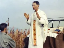 Father Emil Kapaun celebrates Mass using the hood of a Jeep as his altar on Oct. 7, 1950.